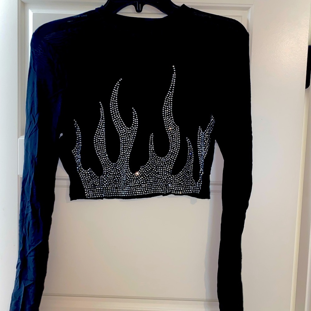 Long sleeve, see through top with rhinestone one fire design.